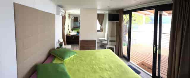 Modern hotel room with bright green bedding, perfect for retreats and meetings.