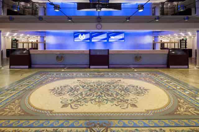 Elegant event space at Oper Frankfurt with tiled floor and blue lighting. Perfect for meetings.