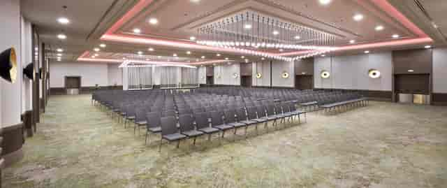 Modern banquet hall at Hilton Frankfurt, featuring sleek chairs for conferences and workshops.
