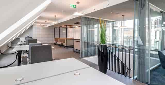 Modern open office in Frankfurt, featuring minimalist furniture for collaboration and productivity.