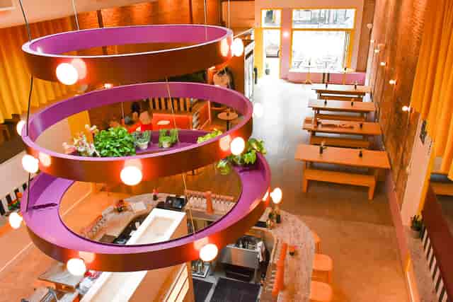Coffee shop event space with modern decor and natural light for networking or casual gatherings.