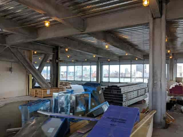 Spacious unfinished venue on Dock 72, ideal for events with skyline views.