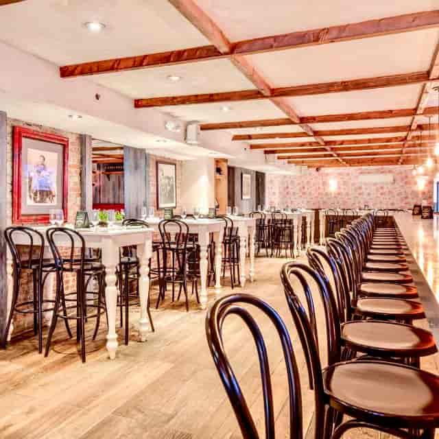 Elegant event space at Arte Cafe with sleek chairs, perfect for corporate meetings or gatherings.