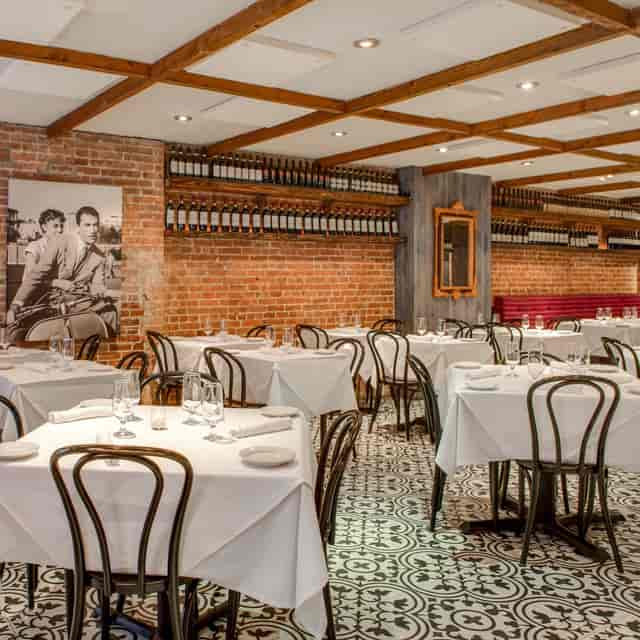 Charming cafe interior with rustic brick walls, perfect for intimate events or meetings.