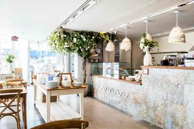 Stylish café in Maman with greenery, ideal for meetings and events.