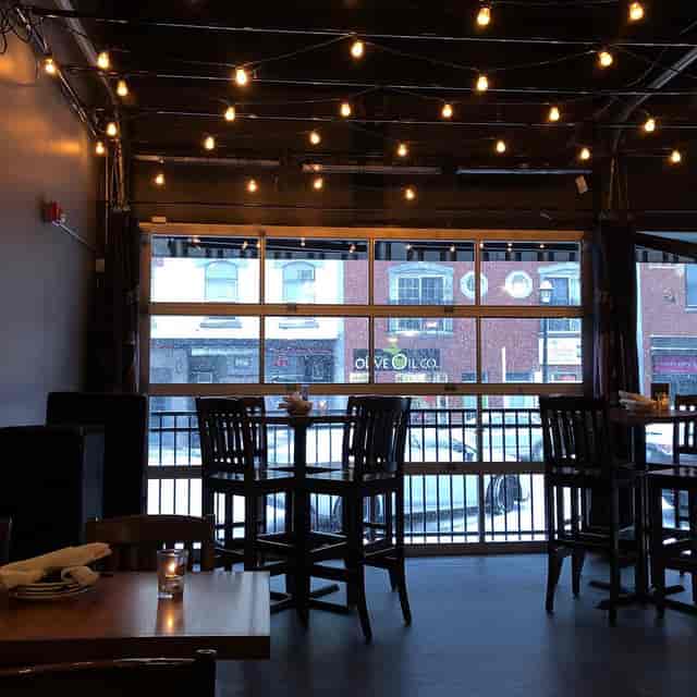 Cozy Ascent Lounge bar with string lights, perfect for winter gatherings and holiday parties.