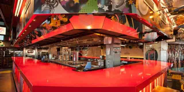 Private room in StreetXO: vibrant modern kitchen for culinary events and interactive classes.