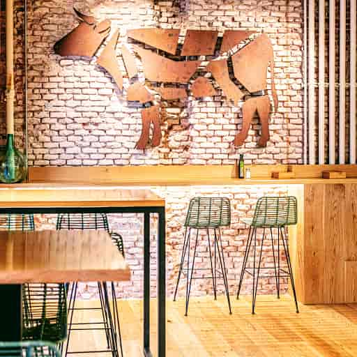 Stylish bar with dog-themed art, ideal for casual meetings and networking events.
