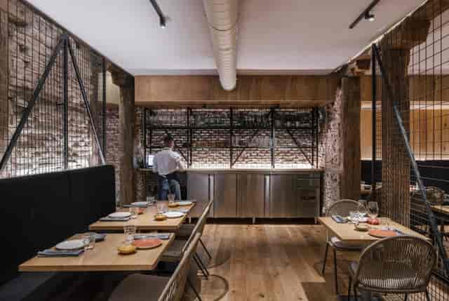 Modern industrial bar with warm wood accents, perfect for informal meetings and events.