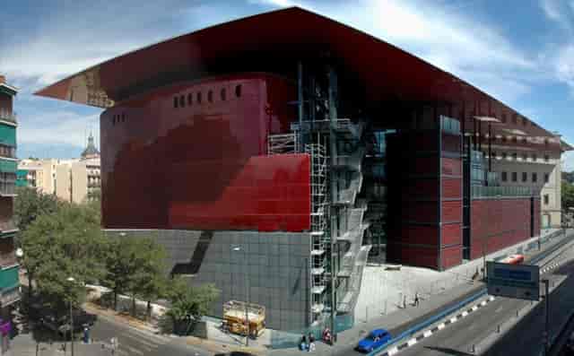 Auditorio Sabatini at Reina Sofía, striking red glass architecture for conferences and events.