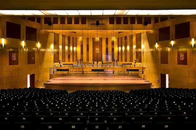 Spacious Palacio Municipal auditorium with polished wood, ideal for conferences and performances.