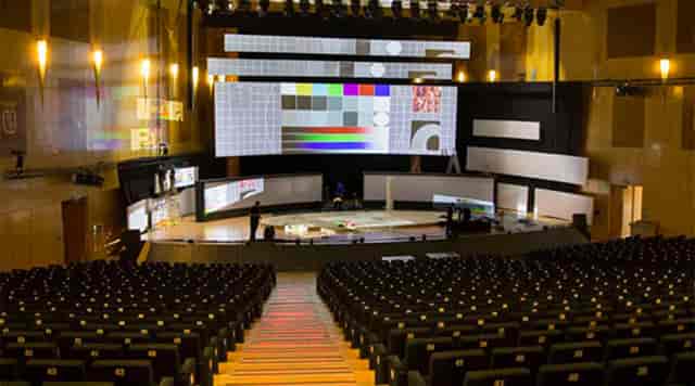 Meeting room auditorium with large stage, perfect for conferences and corporate events.
