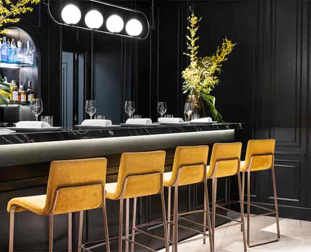 "Sala Club at Hotel Emperador: Modern bar with yellow chairs, ideal for cocktail receptions."