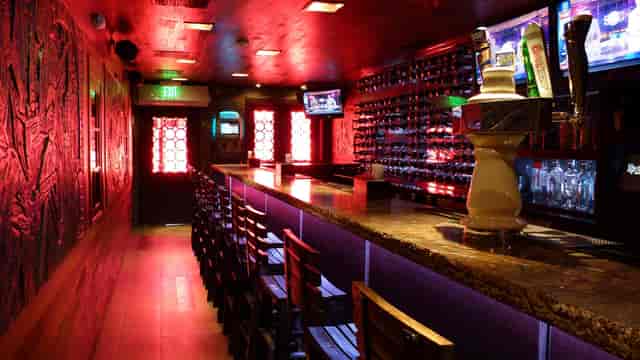 Sleek bar at Adega Grill, ideal for intimate gatherings and networking events.