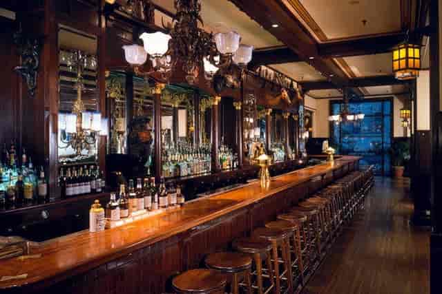 Elegant bar at Old Ebbitt Grill, rich wood finishes for networking events and receptions.