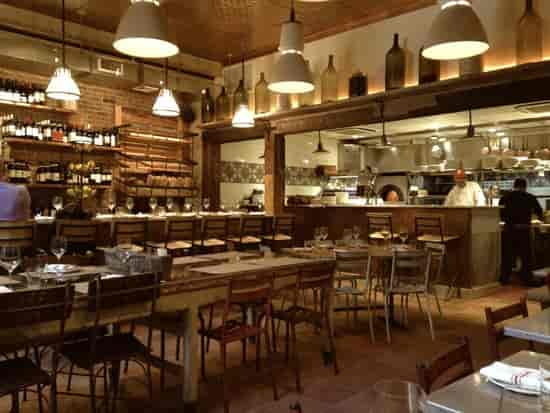 Cozy salumeria with rustic decor for events and wine tastings at il Buco Alimentari.