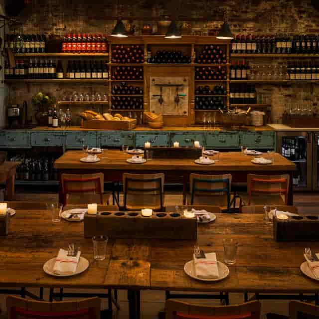 Cozy rustic dining setup at Salumeria for intimate events with warm wood tones.