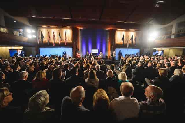 Professional event at National Press Club with a well-designed stage and engaged audience.
