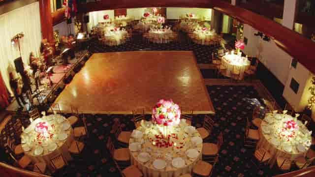 Elegant conference center with round tables, perfect for weddings and formal events.