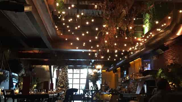 Warmly lit Pergola dining room with flexible seating for events and gatherings.