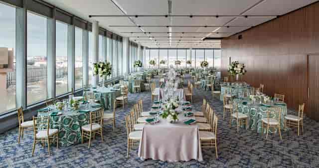 Elegant event space in Emissary with teal linens for corporate gatherings or galas.