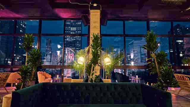 Stylish event space at Isla & Co. with city skyline, perfect for networking and gatherings.