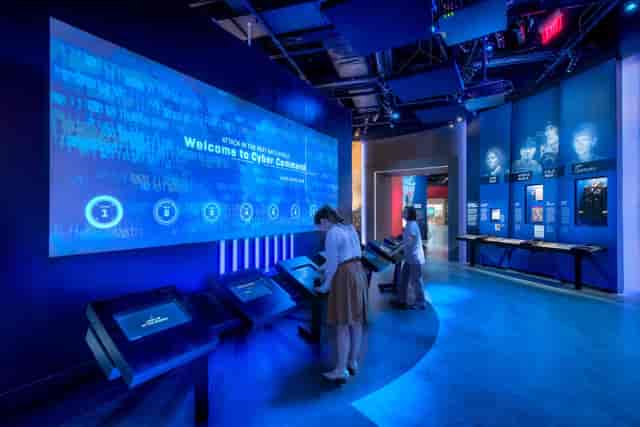 Exhibits at International Spy Museum showcase cybersecurity with interactive displays in a modern space.