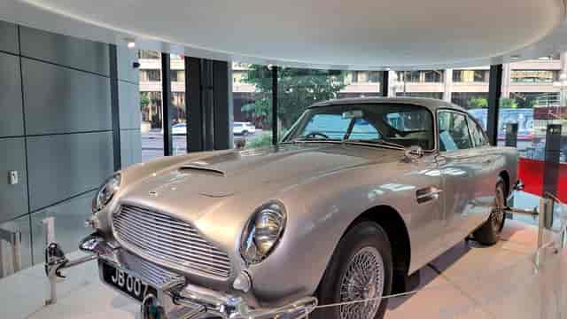 Aston Martin centerpiece in modern event space at International Spy Museum for luxury events.