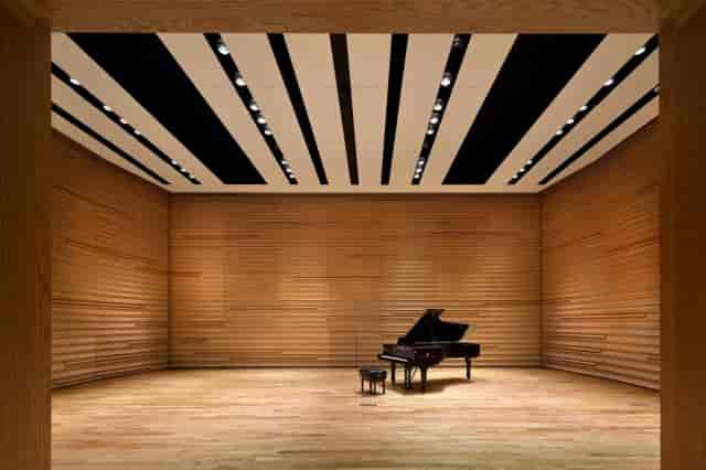 Modern concert hall with grand piano, ideal for classical music and corporate events.