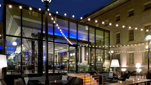 Modern outdoor cocktail bar with ambient lighting, perfect for receptions and gatherings.