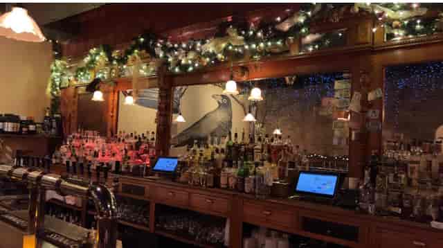 Live music bar at The Crown & Crow with elegant wooden design and vibrant atmosphere.