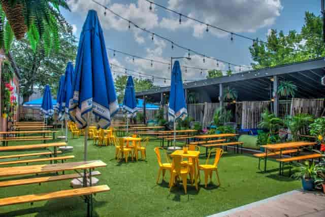 Vibrant Hook Hall garden venue with blue umbrellas, ideal for summer events and gatherings.