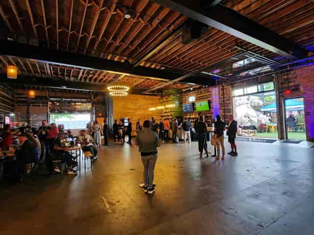 Hook Hall's industrial-chic event space with exposed beams, perfect for networking gatherings.