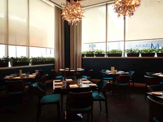 Modern lounge in Modena with stylish chandeliers, perfect for gatherings and meetings.