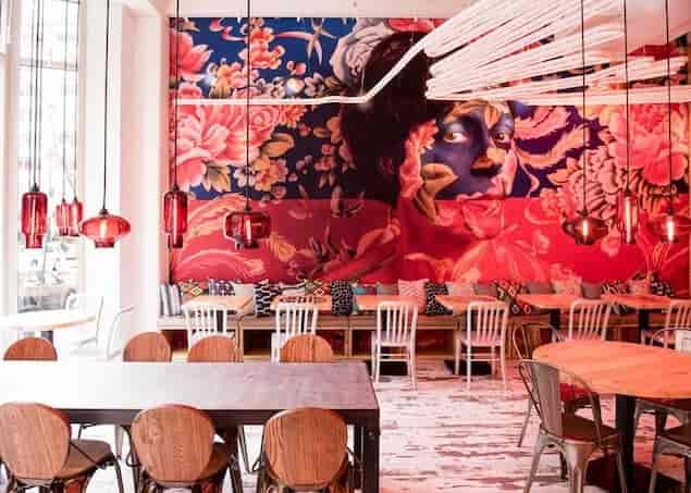 Vibrant event space with floral mural, ideal for networking and gatherings in China Chilcano.