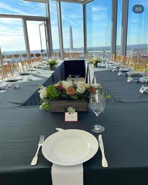 Elegant event setup at Back Bar, The Henri DC, with black linens and floral centerpieces.