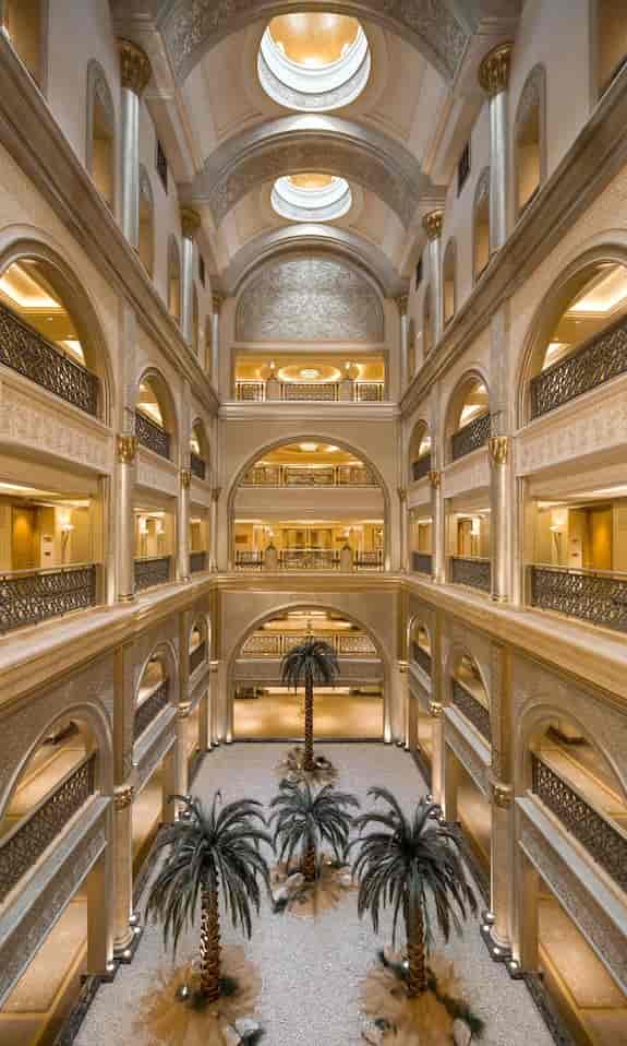Luxury hotel atrium with elegant arches, ideal for conferences and networking events.