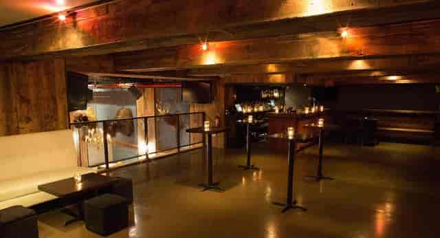 Versatile event space with rustic beams, ideal for gatherings and cocktail receptions.