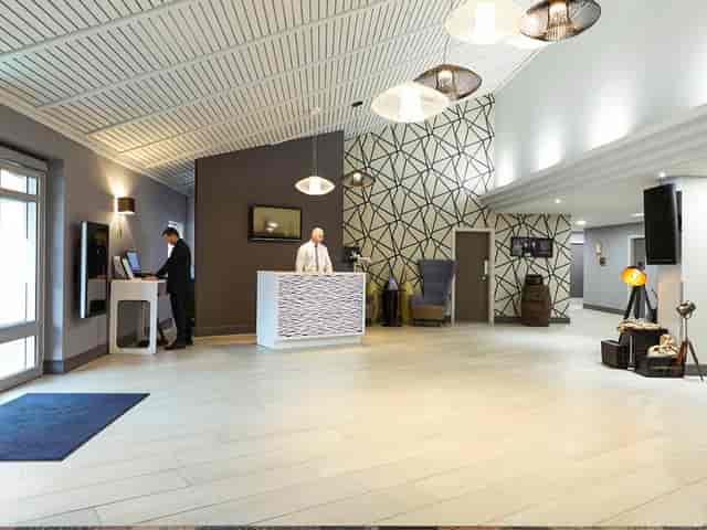 Modern meeting room in Novotel Manchester West, ideal for networking events and conferences.
