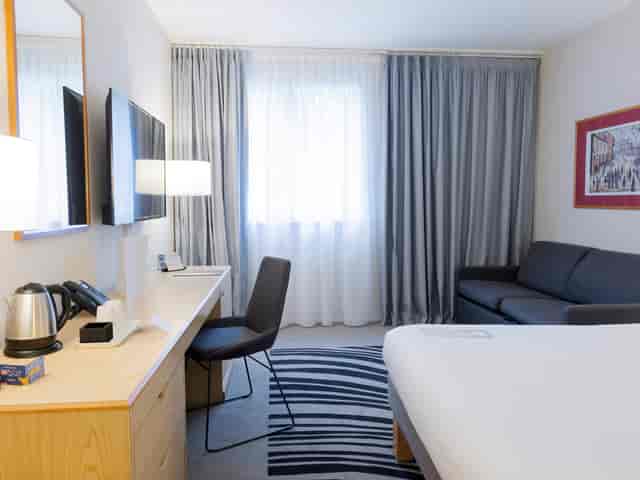 Meeting room at Novotel Manchester West with ergonomic workspace, perfect for corporate events.