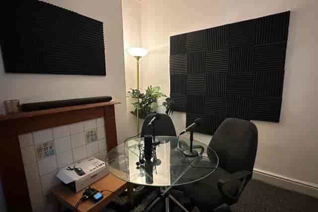 Soundproof podcast studio with microphones for meetings and collaborations.