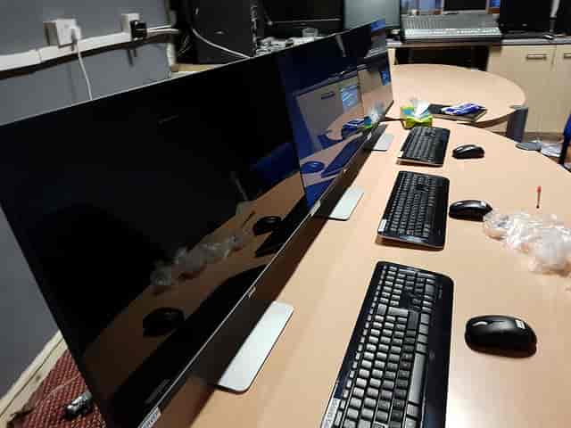 Workspace of a professional website designer with dual monitors for tech presentations
