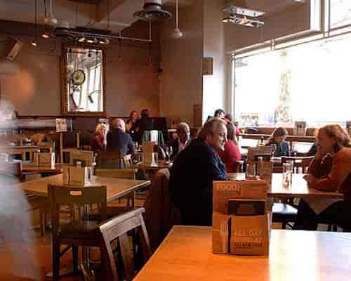 Cozy café bar in All Bar One Manchester, perfect for casual networking events.
