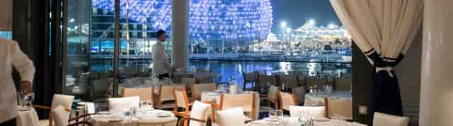 Bellini Lounge waterfront dining with elegant tables, ideal for upscale events and receptions.