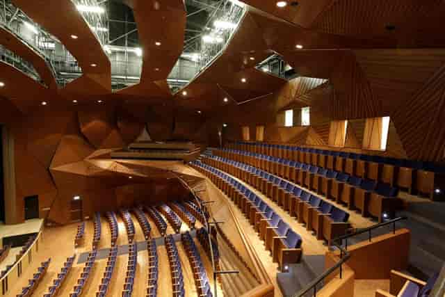 Modern auditorium with wooden panels for conferences and presentations in Performing Arts Center.