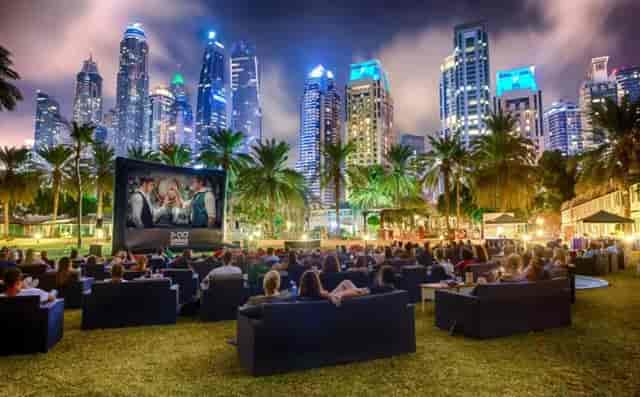 Outdoor drive-in movie theater with palm trees, ideal for corporate retreats and gatherings.