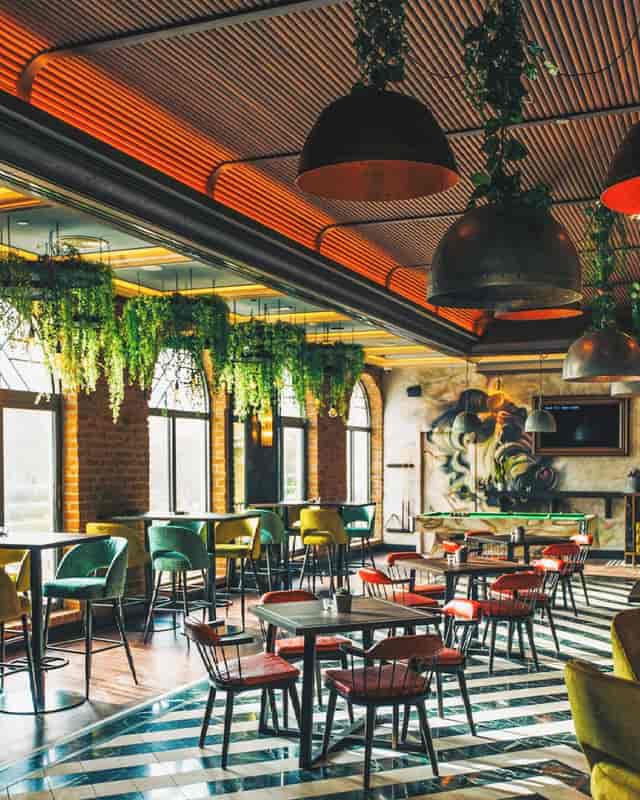 Vibrant Green Room restaurant with sleek tables for events and networking.