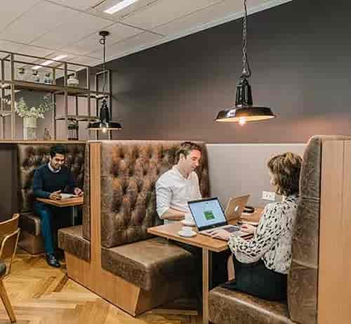 Cozy Servcorp training room with plush booths, ideal for meetings and brainstorming sessions.