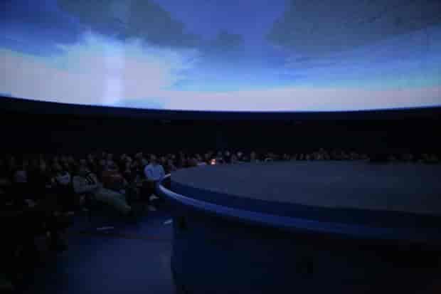 "Planetarium dome theater with engaged audience for science education events"