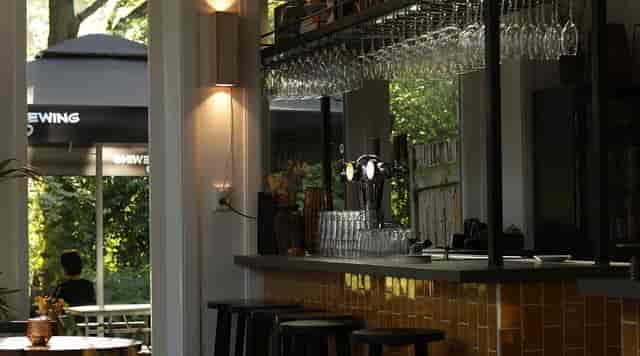 Stylish bar at The Old Bell with glassware, perfect for networking events and gatherings.
